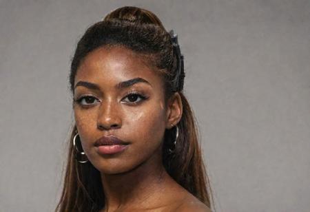 Create a captivating portrait of a beautiful Caribbean woman with, realistic light freckles, enchanting light brown eyes, embodying the spirit of a Caribbean influencer and Instagram model. Showcase her authentic beauty with a touch of natural charm, realistic ambiance lighting, and light makeup, emphasizing her captivating features and unique allure, full body, office setting