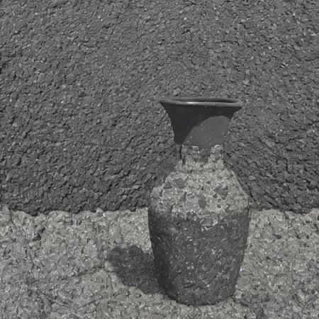 (vase asphalt:1.2), weathered, dark, simple background  <lora:asphalt-000001:1>