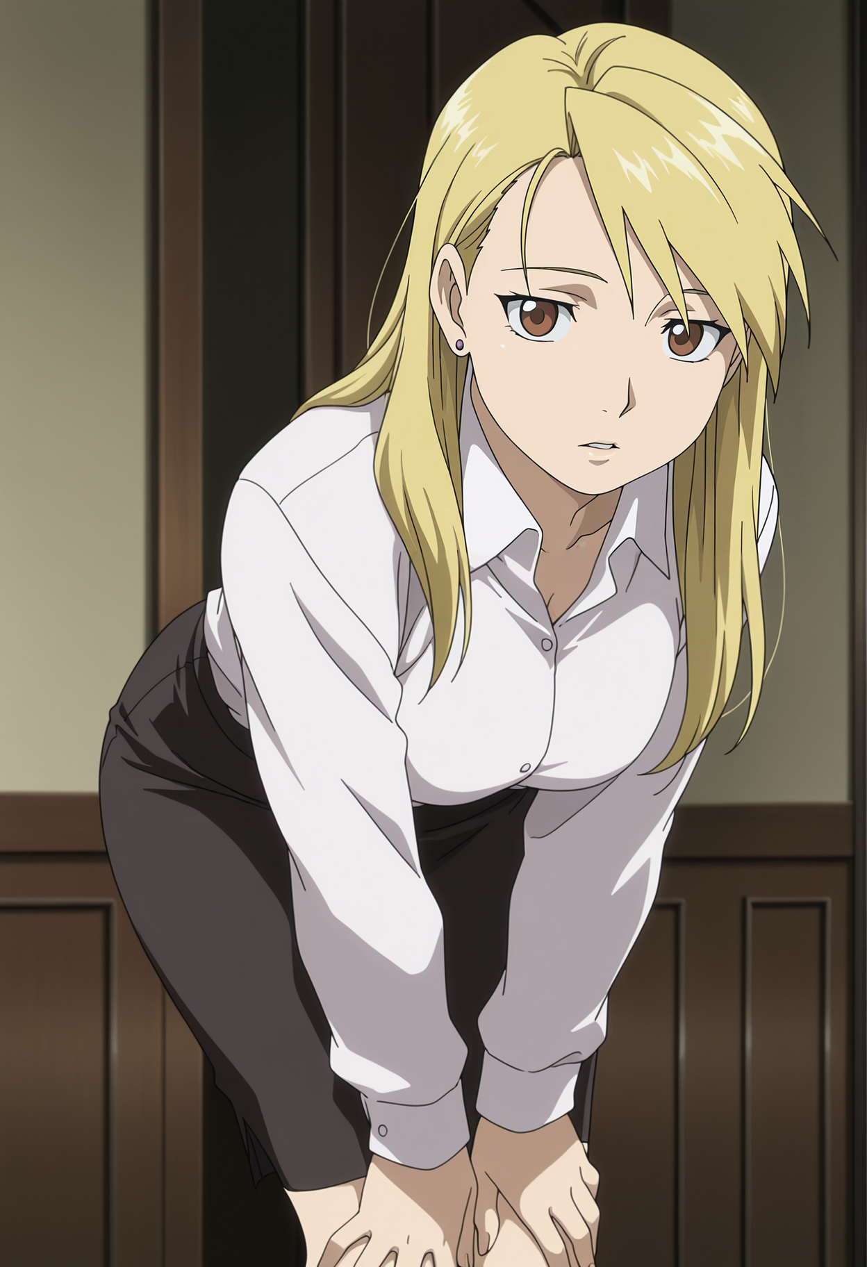 A woman with brown eyes, blonde hair, and a slightly concerned expression leaning forward with her hands resting on her knees. She is wearing a white, button-down long-sleeved shirt and a dark gray pencil skirt, along with small stud earrings. The background suggests an interior setting with dark, vertical wooden paneling and a door.