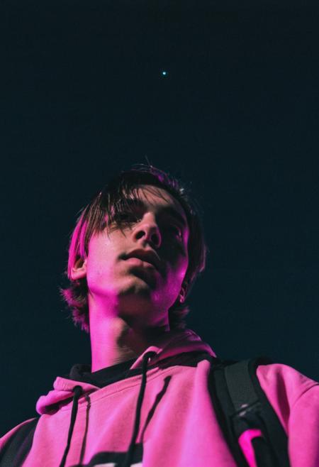 go pro photo, half body,1man, 25 y.o. , low angle, night , bright clothes 90's, grainy photo, analogue glitch effect, emo, black and pink colors in clothes