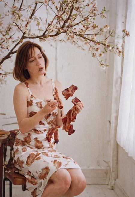 Model photography, the 1990s, bacon, a tree with bacon leaves, beautiful, in a white room, beautiful bacon blossom tree, a female eating bacon, wearing a brown dress, white lighting, film grain, DSLR