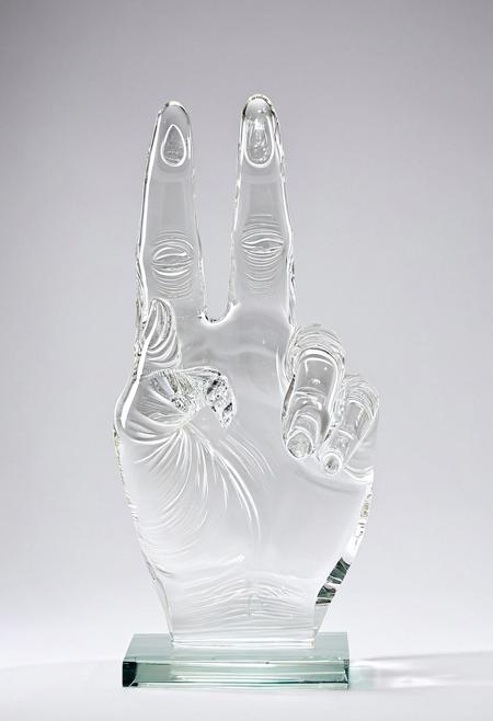 A clear glass sculpture showing the middle finger