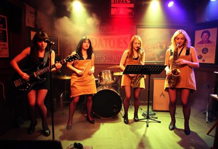 "The Idaho Potatoes", An all female 'New Wave band from Boise Idaho, Aoife on Guitar, Brigid on Drums, E.M. on Keyboards, Gwyneth on Saxophone, all dressed in old potato sacks and fishnet stockings, They are performing on stage in a small smoke filled pub in Birmingham England, somehow a 'producer' had seduced E.M. and left her pregnant-then abandoned them after he took all their money and left them in the middle of a Birmingham street, They hope to make it big in the coming decade (the 1980's), but Gwyneth is doubtful and is thinking about leaving the band,