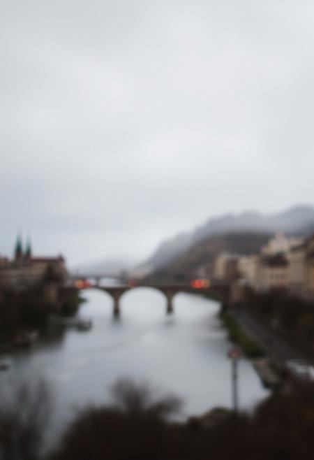 High contrast, low key lighting, blurred bokeh effect, sharp subject focus, soft background, deep shadows, dramatic effect, impressionist style, serene landscape with rivers and bridges, natural light, broken brushstrokes, muted palette, duality and contrast themes.