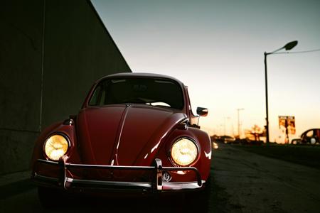 analog gloomy photo of a (red) Volkswagen Beetle car, <lora:vwb33tl3:1>, sunset, decayed and dilapidated suburbs, 1969, ((horror movie)), slasher film, High Detail, Sharp focus, ((photorealism)), realistic, best quality, 8k, award winning, dramatic lighting, epic, cinematic, masterpiece