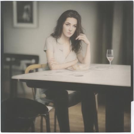 highly realistic adult woman as a glossy polaroid on the table  <lora:glossyphotov3-notfullytrained:0.7>