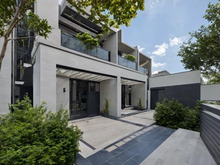 Architectural style, <lora:JJsRowHouse_XL:1>,(masterpiece) , (best quality), ((RowHouse)), dramatic lighting, high quality outdoors, sky, day, cloud, tree, blue sky, building, scenery, road, real world location,  sunlight, enough detail, high resolution,super realistic, Photorealistic, highly detailed, balcony, plants, door, gate, paving, . Clean lines, geometric shapes, minimalist, modern, architectural drawing, highly detailed