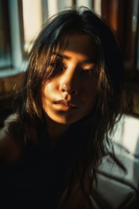 In a low-key style with the grainy texture of expired film, the photo offers a close-up view from above of a photo-realistic close-up medium shot of a beautiful girl's figure laying down in a bathtub, depicted in full body. One hand is reaching down out of the bathtub, holding a wine bottle. The attention to detail captures every nuance of the subject's features and attire, creating a lifelike representation that almost breathes with realism. Against the backdrop of vibrant, full-color, saturated neon city lights visible through the big windows, the scene comes alive with a plethora of hues and tones, infusing warmth and urban energy. The subject's expression exudes a sense of calm amidst the bustling cityscape. Bathed in the dim neon-colored light from the blacked-out large windows showcasing the city's glowing neon signs, the scene is a captivating mix of dramatic shadows, heightened by a subtle rim light tracing along her silhouette, and accentuated by a soft hair light adding dimension and allure to her hair strands.