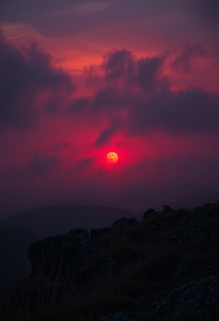 A crimson-hued sunset descends upon a rugged terrain, where wispy clouds and misty fog envelop the landscape in an eerie atmosphere. A dark, muted palette dominates, with deep oranges and purples bleeding into the distant haze. Cinematic lighting casts long shadows, imbuing the scene with dramatic tension. The camera pans across the terrain, capturing every nuance of fine detail, from the wispy grasses to the weathered rocks. A masterpiece of composition and atmospheric mastery, this breathtaking image demands attention.
