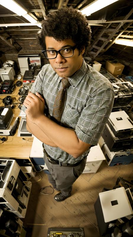 modelshoot style, Richard Ayoade as Moss, plaid shirt, paisley tie, drone shot, standing looking up with arms crossed, basement office, intricate details, intricate detailed face, 4k, 8k, hdr <lora:Richard-Ayoade-v10:0.7>