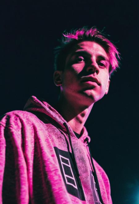 go pro photo, half body,1man, 25 y.o. , low angle, night , bright clothes 90's, grainy photo, analogue glitch effect, emo, black and pink colors in clothes