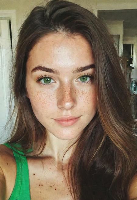 instagram selfie, upper body, a 23 year old gorgeous woman, busty, slight smirk, detailed skin face and eyes, natural lighting, at home, long hair, low contrast, natural face, freckles, brunette hair, green eyes
