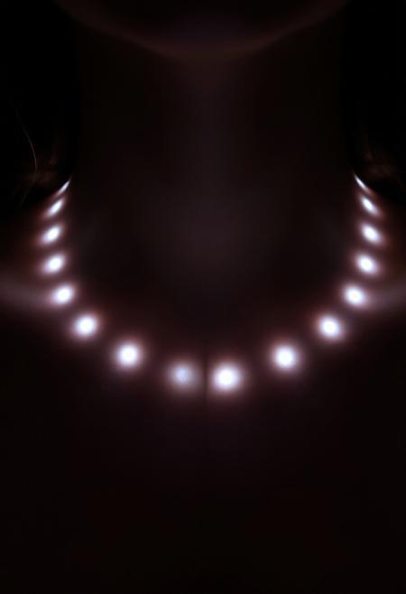 subdermal LED halo necklace, (internal LED glow:1.7), (embedded LEDs:1.8) forming evenly spaced glowing rings beneath the skin, (radiant circular light patterns:1.6) surrounding the neck, soft, diffused light radiating outward from the collarbone, (delicate glowing halos:1.6) mimicking the elegance of a classic halo necklace, (natural skin tone:1.5), high-definition, (ultra-realistic skin texture:1.8), smooth light transitions, seamless integration of light beneath the skin, (no visible jewelry:1.8), (worn necklace:-1.8), (chains:-1.8), perfect for formal and casual settings, modern and timeless elegance, radiant yet minimalist design