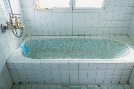 masterpiece, high quality,  a Taiwan old bathtub with a blue and white tile floor and walls and a shower head and a faucet ,8k uhd, dslr, soft lighting, high quality, film grain, Fujifilm XT3<lora:1_Taiwan old bathtub_1v5_768_0001BD5e_NR128NA128off:0.8> tile floor, bathroom tiles, tidy