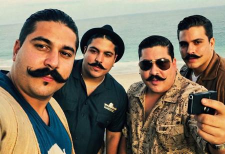 moody instagram photo of fat mexican Cartel guys taking a selfie, instagram selfie, making funny faces, in the drug lab, holding guns, big black mexican mustaches, tan skin, wearing mexican ponchos, guns in the background, holding ak-47, perfect face, perfect eyes, perfect hands, pablo escobar, disposable camera, bright beach, iPhone 4 quality, 1987 camcorder quality, pov from above, iPhone flash, camera flash, grainy, low quality, motion blur