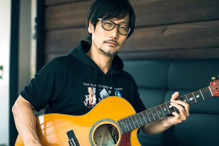 <lora:hideoKojima:1>, hideokojima,  Best quality, masterpiece, ultra high res, (photorealistic:1.4), 1 man,  detailed skin, (playing guitar), on the street, oversized green hoodie,, best quality, ultra high res, (photorealistic:1.4),