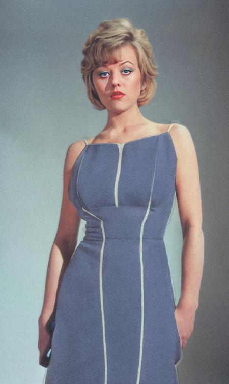 A (sfw:2.9) professional 1970s photo of margaretnolan woman, standing, (looking at viewer:9.1), for a women's interest magazine, wearing a blue evening dress, (best quality:1.2), (intricate details)