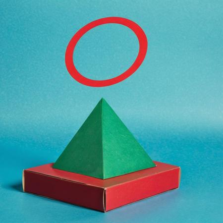 a green pyramid on a blue box and a red circle in background