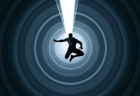 A chrome and silver beam hitting an athletic superhero  100 metres away. The beam is about 1 metre thick and surrounded by multiple concentric grey and white circles of varying diameter. The target is silhouetted and is in an action hero acrobatic pose