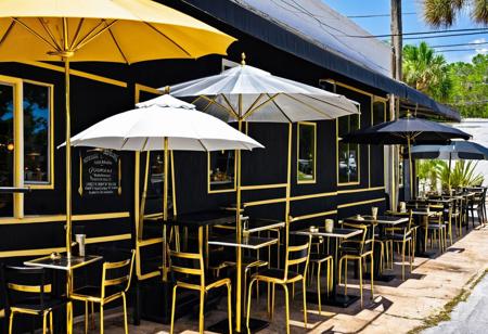 Surreal, beautiful gold and silver umbrellas and black and gold tables at a small cafe in New Tejas, Florida