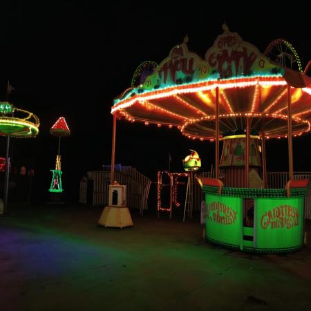 <lora:liminalspaces768:1> , liminalspaces, A desolate carnival at midnight, its empty rides coming to life with ghostly apparitions, their haunting laughter piercing the silence.