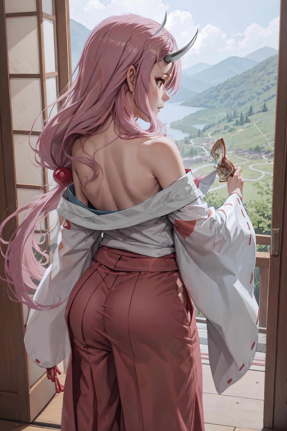 A woman with pink hair and pink pants stands by a window.