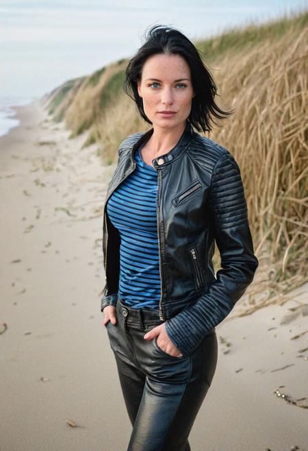 Stunning analog photo of a beautiful 38 years old Dutch woman, striped t-shirt, leather jacket, leather pants, perfect face, absolute beauty, sexy pose, natural raven black hair, hair pulled back tight, blue eyes, freckles, freckles and moles all over body, absolute perfect tits, big tits, soft natural tits, walking the beach in Zeeland, early morning, misty, soft natural early morning light light, ultra realistic, extremely detailed