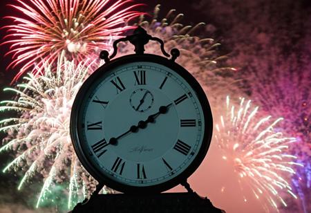 clock, closeup, fireworks in lower frame, bright flashing light, colors, fog and haze