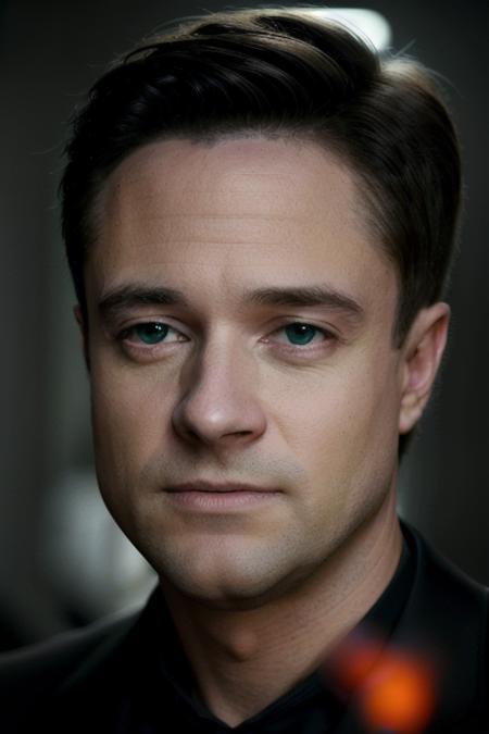 a man in slick black business suit <lora:topherGrace:1>, looking at camera, dark cinematic lighting, [smiling, angry], ready for action, 8k, raw, uhd, close up, perfect face, clear eyes