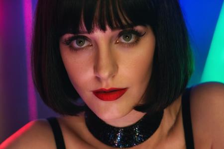 face close up, stunning woman, 20 years old, [Julia Voth | Eva Green], (dark bob short hair, blunt bangs), (spiderman outfit, cleavage, large breasts), dim lights, indirect neon lights, cinematic still, masterpiece, high quality, UHD, vivid colors, HDR, (confident and graceful posture, radiates contemporary elegance and style), detailed hands, perfect hands, pinup \(style\),