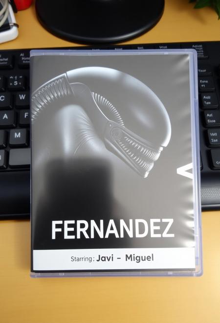 This is a photograph of DVD case with a desk background. The case features an alien and a xenomorph as in alien vs predator movie and a prominent black bold text "Alien VS Fernandez", Below is a bullet list of features: "Starring", "Javi" and "Miguel".