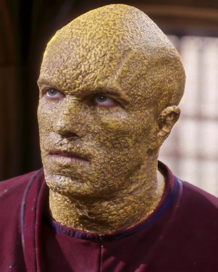 suliban alien yellow mottled bumpy skin bald yellow eyes