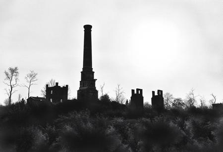 A lonely chimney of in the remains of former crematorium building. There are some ruined furnaces nearby. The background for the ruined, cold chimney is the bright daylight in the summer. No clouds, only hot August sun.
The picture is created in black and white watercolour technique, wherever possible black background is preferred.
The whole landscape is inspired by the atrocities of concentration camps and is the silent homage to the victims of the factories of death.