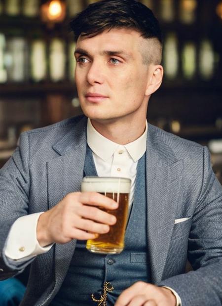 <lora:Thomas Shelby:1>, A stunning closeup intricate full colour portrait of (man:1), (sitting down, holding a pint of beer), 
epic character composition,
by ilya kuvshinov, alessio albi, nina masic,
sharp focus, natural lighting, subsurface scattering, f2, 35mm, film grain