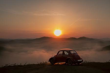 analog gloomy photo of a (dark red) Volkswagen Beetle car, <lora:vwb33tl3:1>, ((three quarter view)), (dark sunset), driving on a dirt road, ((dilapidated town)), 1969, ((horror movie)), slasher film, texas chainsaw massacre, amish cult, film grain, retro,  High Detail, Sharp focus, ((photorealism)), realistic, best quality, 8k, award winning, dramatic lighting, epic, cinematic, masterpiece, ambient fog:1.4,