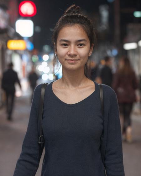 A well lit candid closeup street portrait photograph of a normal, yet beautiful woman walking down the street