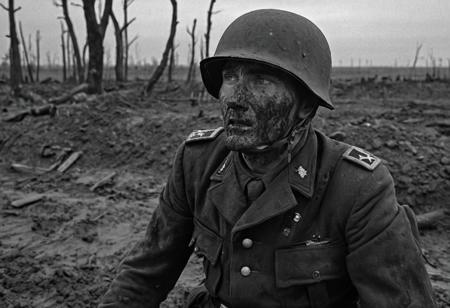 1 man, world war 2 soldier on the Eastern Front, (dying), (explosions), face in shadows, black and white, bleeding out, exhausted, German Soldier, Stahlhelm helmet, muddy field, bleak landscape, last moments, <lora:Desolation:1.1>