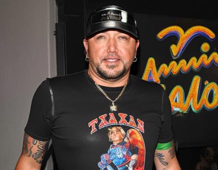 Jasonaldean person wearing a gay pride ((tight leather bodysuit)) alone outside a ((small town gay nightclub in texas)), ((lipstick)),