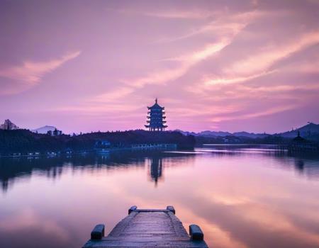 jiangnan,a pier with a person standing on it at sunset or dawn over a lake with a pagoda in the background, scenery, sky, cloud, outdoors, reflection, water, tree, mountain, bridge, <lora:jiangnan:1>