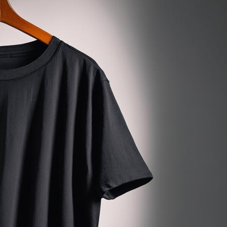 a close up of a black t-shirt hanging on a hander, isolated background, studio lighting, product photography, professional, 4k, candid, romantic, artistic, beautiful, sharp focus, extremely detail, detailed, color, perfect, dramatic, glowing, elegant, intricate, sublime, highly decorated, light shining, rich deep colors, amazing awesome, symmetry, fine