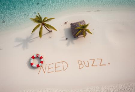 aerial view of tropical desert island beach with broken life raft and makeshift shelter made of palm leaves. There is written text on beach sand by a survivor "NEED BUZZ"