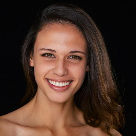 studio portrait of T1T0N, black background, alluring smile
