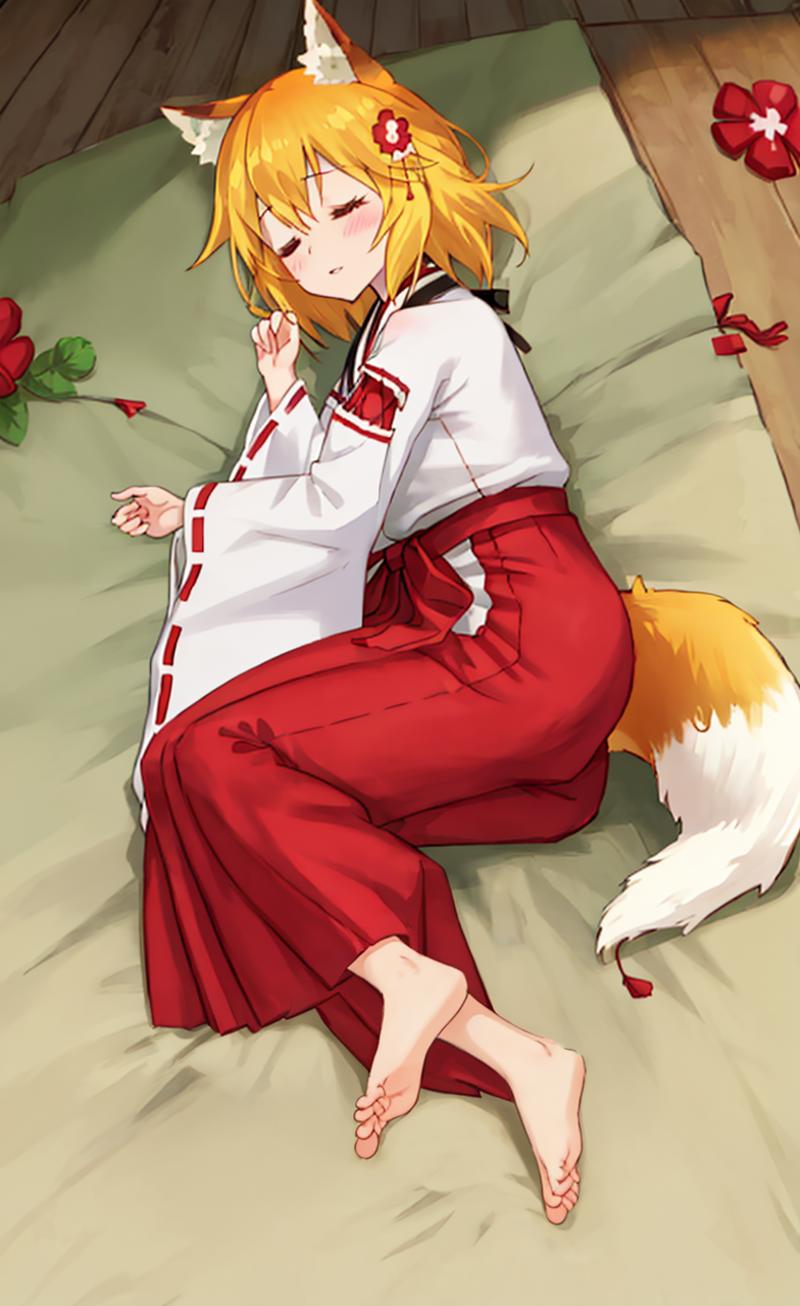 A girl in a red kimono lays on a bed.