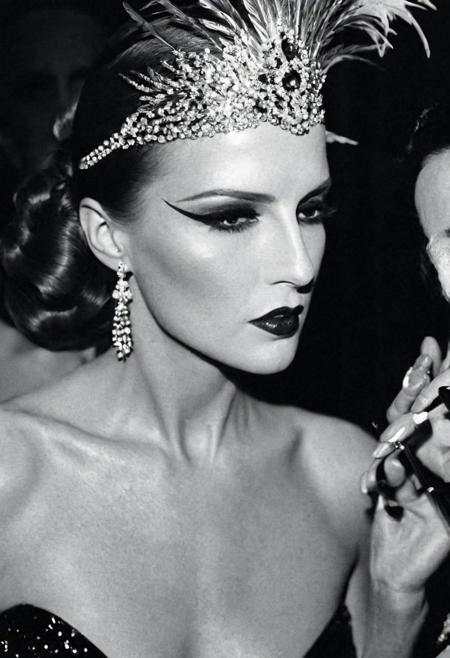 Photo by <lora:HELMUTNEWTON-000001:1> HELMUTNEWTON, photographer,  Close-up, High Key Lighting ,Fujifilm Provia 100F, “Cabaret Glamour”: Backstage at a burlesque show, a dancer adjusts her feathered headpiece. Sequins, red lipstick, and smoky eyes create an aura of sensuality. ,, fashion editorial photography, high-fashion imagery, avant-garde aesthetics, editorial storytelling, conveying fashion trends and concepts, artistic interpretation, expert styling, professional lighting, capturing fashion-forward visuals, creating visual impact, evoking emotion, pushing creative boundaries, large saggy breasts, deep cleavage, hard nipples,