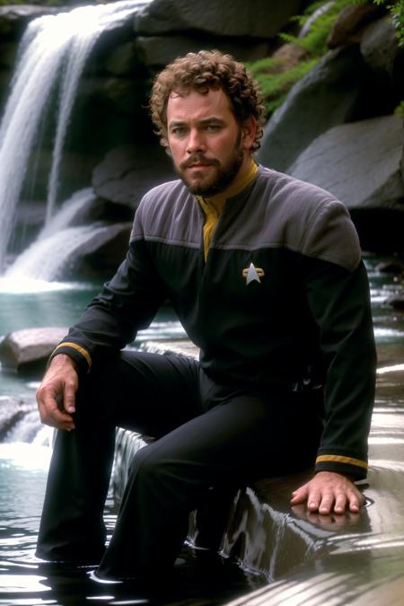 man with curly hair and beard in black and yellow ds9st uniform,sitting on a rock near a waterfall, 8k uhd, dslr, soft lighting, high quality, film grain,masterpiece quality,Fujifilm XT3<lora:DS9_768V12:0.8>