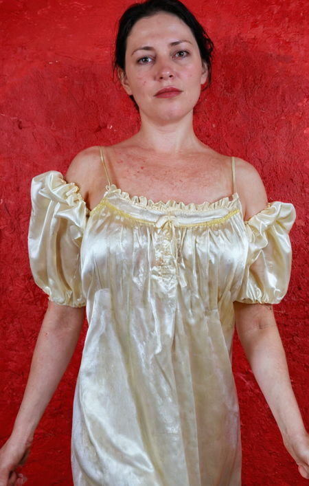 Nancy is a white woman, Nancy has white skin, Nancy wears satin Nightgown from ebay, satin nightgown, close-up photo of Nancy stands three-quarter side view, full detailed face, fake cheeks, sweating face with coily black hair, Wrinkled loose skin with pores, Velvety, skin moles, Mature skin, lipstick, RAW photo with a dark photo,high contrast photo, high detailed photo, 4K, texture, Camera RAW, direct light night, mid-night, favela. seductive, atmosphere. detailed background and sharp and detailed, film grain. masterpiece, best quality, amazing quality, newest, highres, high resolution, ultra-detailed, high contrast, cowboy shot, dynamic pose, Detailed natural skin and blemishes without-makeup,