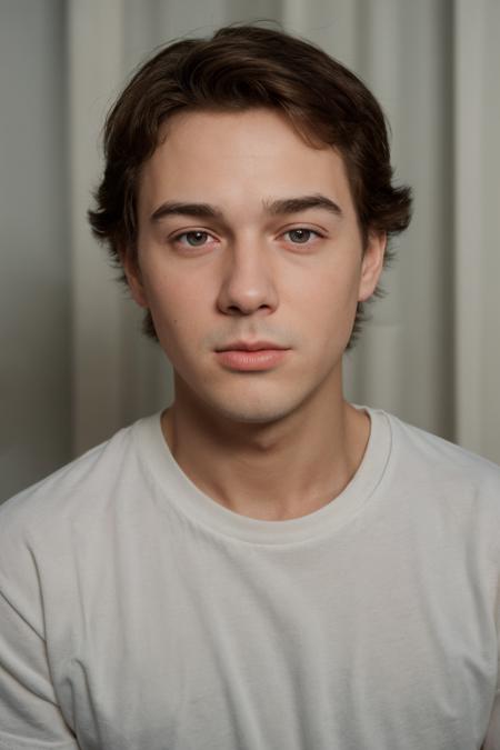 intimate closeup face portrait photo of justin_owen <lora:justin_owen-07:0.75> wearing a classic ringer t-shirt, tight framing on the face, soft, diffused lighting, dreamy feel, simple backdrop, textured curtain